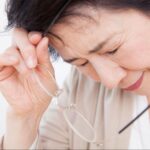 ドライアイがつらくなりメガネを外した女性